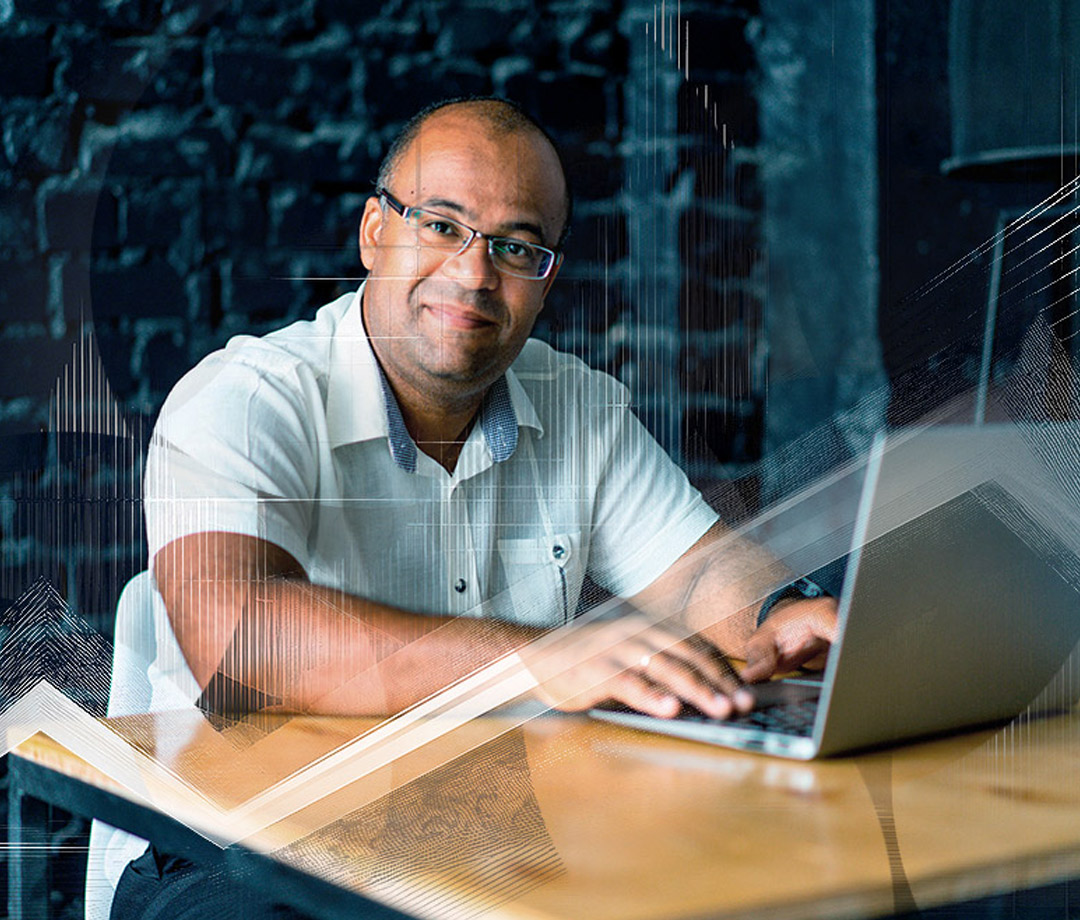Friendly man working on laptop